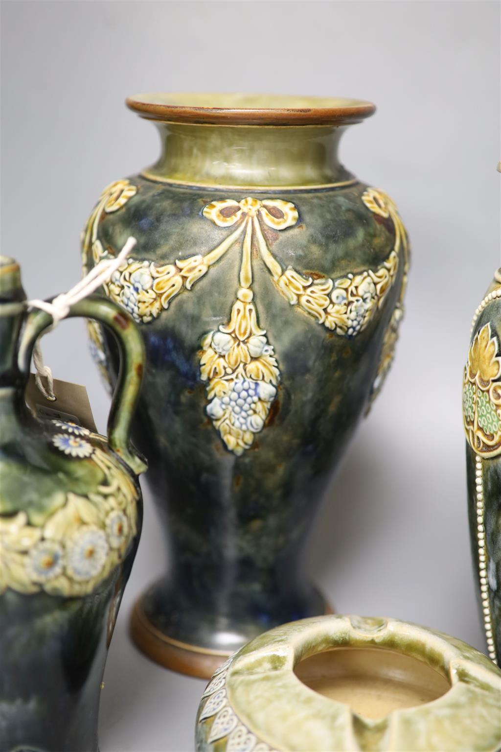A pair of Royal Doulton vases, a similar larger vase and a small flagon